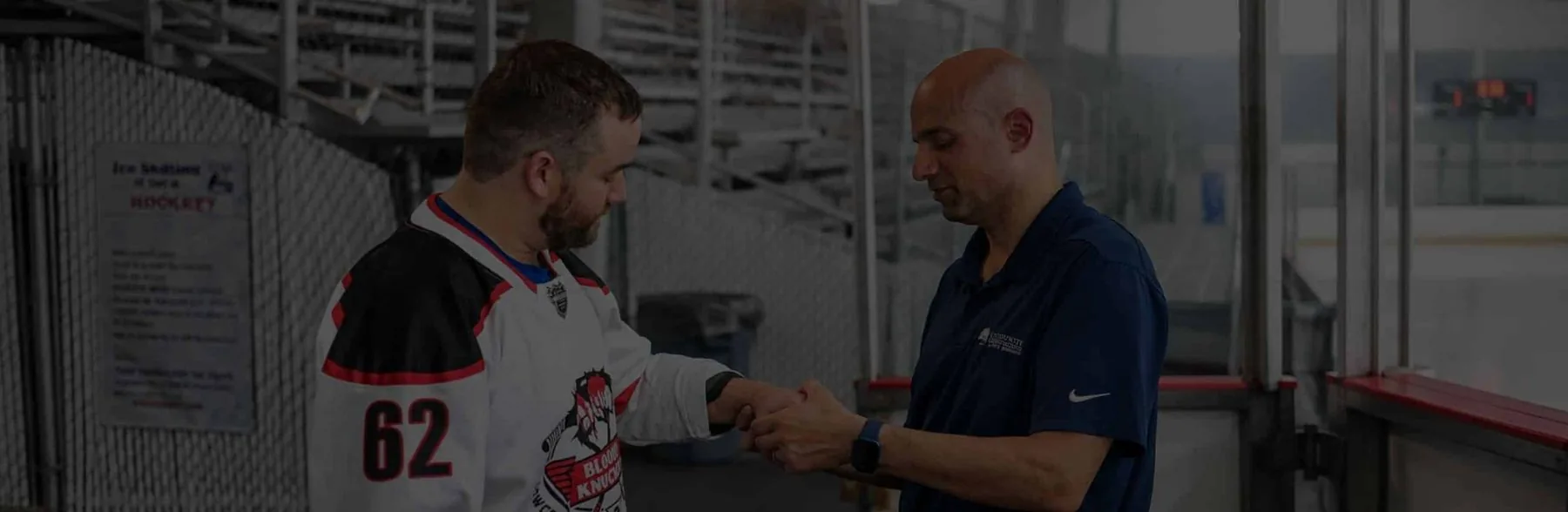 LCO physician examining a hockey player’s wrist